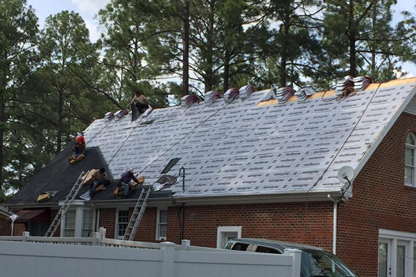 Roof replacement on a brick house in progress