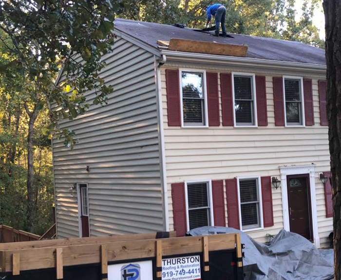 Licensed roofer's team preparing a house for roof replacement